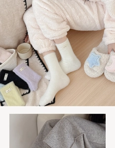 Close-up of thick plush mink velvet socks with lace trim and handmade labels in macaron colors
