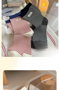 Close-up of striped cotton crew socks featuring stitched egg label and elastic ribbed cuffs