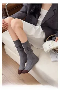 Detailed knit texture of vintage mid-calf socks with dark grey and brown contrast toe