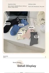 Detail view of five-color cotton crew socks with 05 varsity stripes in a lifestyle setting