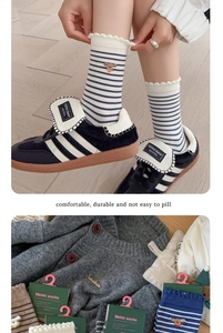 Close-up of cotton sports socks with striped patterns and cute bear embroidery details