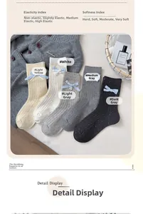 Detail of five speckled mid-calf socks with blue ribbon bows on cozy knit background