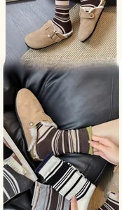 Detail of khaki suede mule slippers with warm faux shearling lining and metal buckle