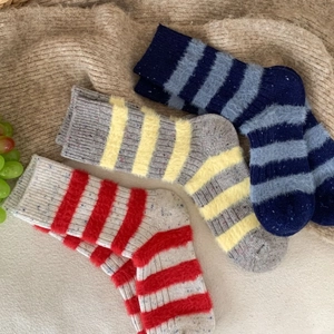 Three pairs of thick wool stripe crew socks with plush texture and Donegal speckles