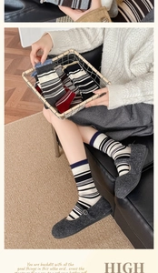 Detail view of Japanese style thick striped wool socks with elastic rolled cuffs for winter