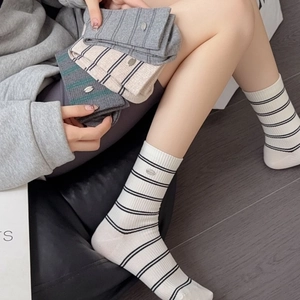Women's striped cotton mid-calf socks with metal logo charm in various neutral colors