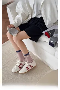 Close-up of striped cotton socks with ribbed cuffs shown in a cozy home setting