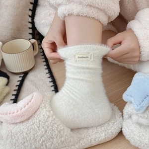 Plush white mink fleece socks for women featuring a handmade label and warm fuzzy texture