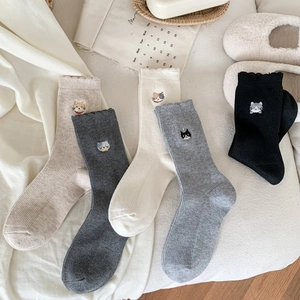 Five pairs of cozy wool-like crew socks with cute cat embroidery in neutral tones