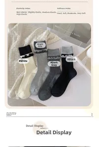 Dettaglio di quattro paia di calze con bordi a balze elastici in bianco e grigio