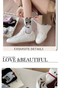 Close-up of white cotton mid-calf socks featuring cute cartoon dog and lettering