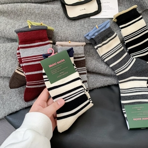 Thick wool socks for women with rolled edges in colorful striped designs for winter
