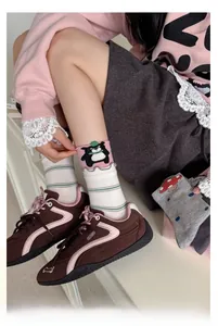 Detail of cotton crew socks featuring cute panda patterns and ruffled edges for women