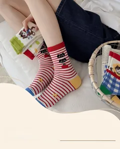 Detail of colorful cotton crew socks featuring creative animal and floral patterns