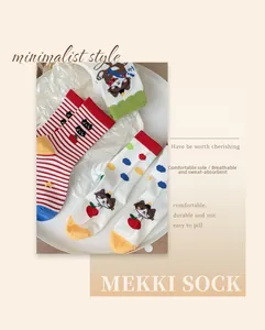 Close-up of colorful cotton socks with cute animal patterns and striped bear designs
