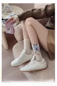 Close-up of knit cotton socks with a cute bear pattern and blue ACCELER text detail