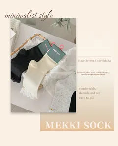 Lace trim on soft cotton crew socks in neutral tones presented in a woven basket