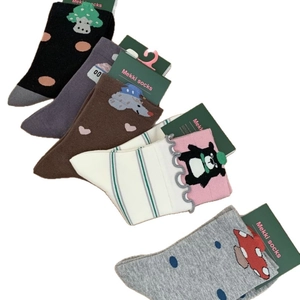 Five pairs of cartoon cotton crew socks with scalloped edges in black, white, and purple