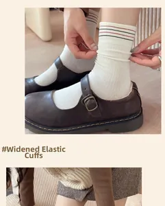 Close-up of ribbed cotton socks with striped elastic cuffs and vintage Mary Jane shoes