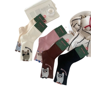 Five pairs of cotton crew socks with cartoon bear patterns in warm neutral colors
