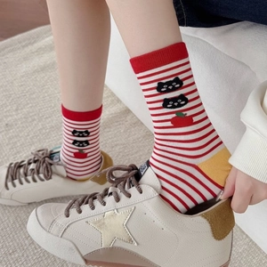 Red and white striped crew socks featuring cartoon cat and apple patterns with yellow heels