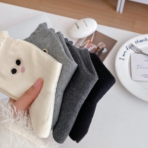 Close-up of cute cartoon large eyes embroidery on ribbed knit cotton crew socks set