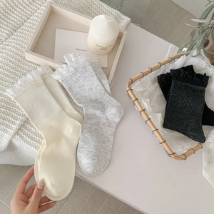 Lace-trimmed crew socks for women featuring ribbed knit texture in neutral colors