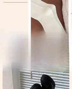 Detail showing white ribbed knit socks with wide cuffs and black casual shoes