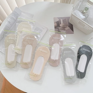 Detailed view of invisible socks in branded zip bags with elegant minimalist packaging