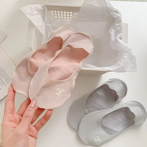 Detail of no-show socks featuring cute bow patterns and delicate scalloped lace edges