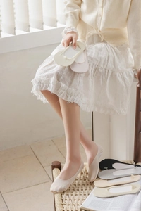 Detailed view of women's low cut invisible socks with elegant white bow embroidery