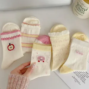 Five pairs of cute women's mid-tube socks with mesh cuffs, dots and apple patterns