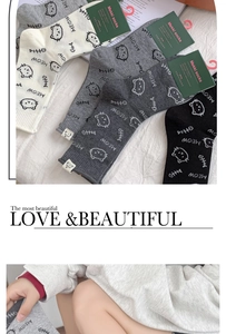 Detail of cute cat pattern mid-calf cotton socks in white, gray and black colors