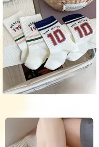 Detail of vintage sporty mid-tube socks with athletic stripes and HEALTI 199 typography