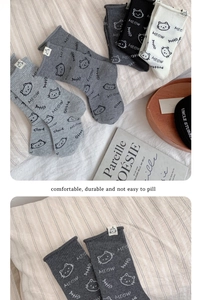 Detail showing the seamless toe and cute cat character patch on these cotton socks