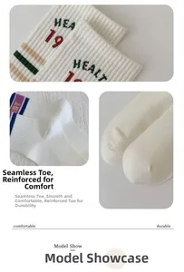 Detail of white cotton athletic crew socks featuring rib knit texture and reinforced toe