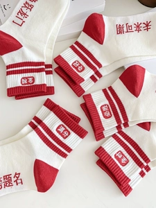 Détail de chaussettes en coton rouge et blanc avec textes de bénédiction pour examens