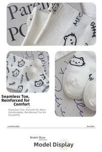 Detailed close-up of seamless toe and cartoon cat embroidery on white knitted socks