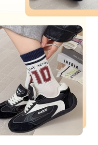 Detail of white mid-calf sports socks with red number 10 and Stay Active slogan