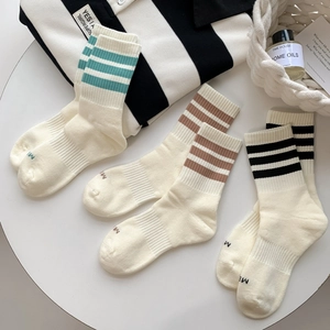 Three pairs of breathable cotton striped crew socks in cream, blue, brown and black