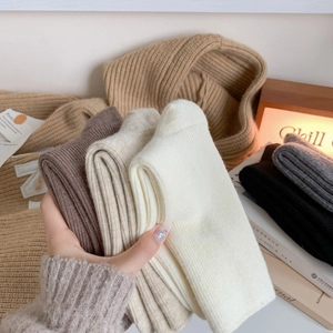 Close-up of thick knitted wool socks in earthy tones for winter warmth and cozy comfort