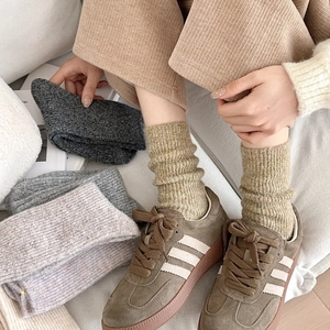 Close-up of thick ribbed texture and warm earth tones on women's wool socks