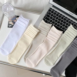 Detailed close-up of seven-pair ribbed cotton slouch socks set in assorted pastel colors