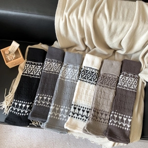 Detail view of Fair Isle knit leg warmers in six neutral colors with ribbed cuffs