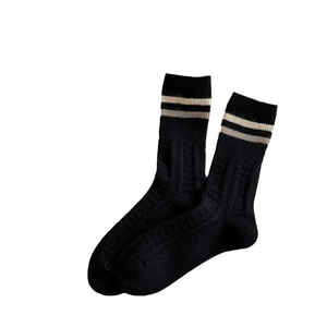Thick wool blend crew socks for women featuring classic black ribbed knit and stripes