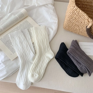 Detailed knit texture of breathable cotton cable knit crew socks in neutral colors