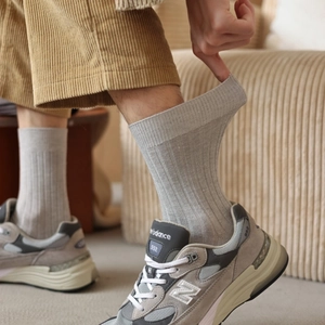 Detailed texture of grey ribbed cashmere-style socks paired with corduroy trousers