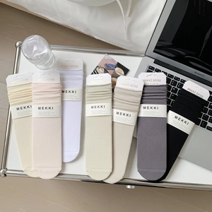 7-pack of ribbed cotton crew socks in neutral Morandi colors laid flat on a clean desk