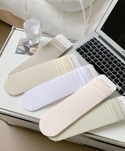 Detailed view of colorful ribbed cotton crew socks with premium packaging tags