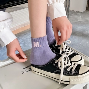 Detail shot of purple cotton sport socks with M embroidery and ribbed cuffs